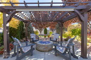 View of patio with a pergola and a fire pit