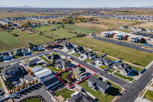 Aerial view of residential area featuring property parcel outlined and a mountain backdrop