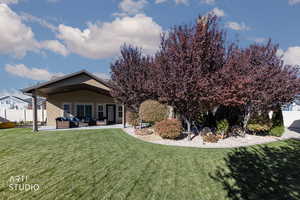 Rear view of property with a patio area, outdoor lounge area, and stucco siding