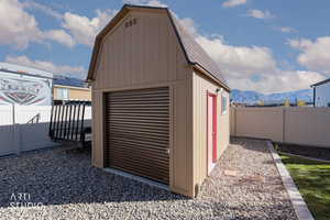 View of outbuilding with a fenced backyard and a mountain view