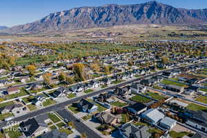 Aerial view of property's location featuring nearby suburban area and a mountainous background