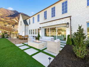 Outdoor living space with a fire pit and a patio