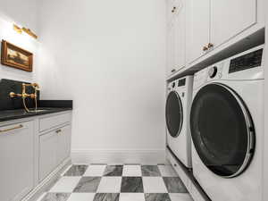 Laundry area featuring built in cabinets