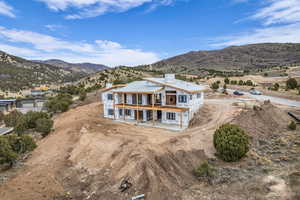 Aerial view of property and surrounding area with mountains