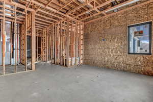 Miscellaneous room with unfinished concrete floors