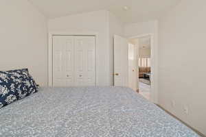 Bedroom featuring a closet and vaulted ceiling
