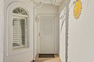 View of exterior entry featuring stucco