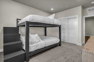 Bedroom featuring light colored carpet and recessed lighting