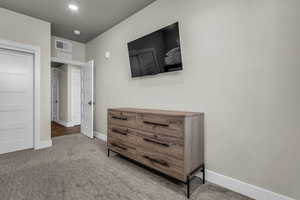 Bedroom featuring light carpet and recessed lighting