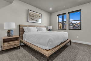 Carpeted bedroom featuring baseboards and recessed lighting