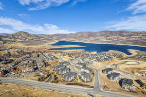 Aerial view of property and surrounding area with mountains and nearby suburban area