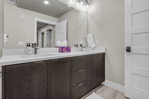 Bathroom with double vanity and recessed lighting