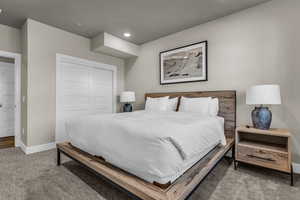 Carpeted bedroom with a closet and recessed lighting