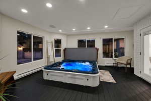 Wooden deck featuring a baseboard heating unit