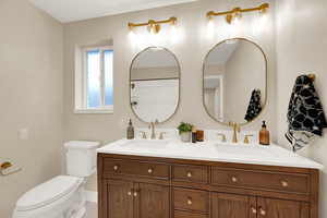 Bathroom with double vanity and a shower with shower curtain
