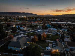 Aerial overview of property's location featuring a mountain backdrop and nearby suburban area