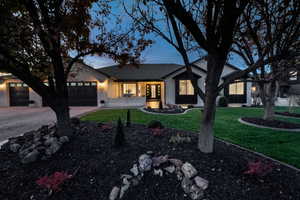 View of front of home featuring a yard, concrete driveway, a garage, and roof with shingles