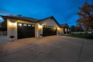 View of front of property with driveway, brick siding, and a garage
