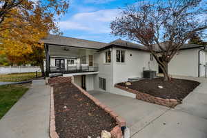 View of front of house featuring brick siding, a ceiling fan, covered porch, and a shingled roof
