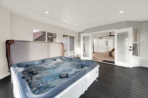 Misc room featuring a jacuzzi, recessed lighting, and dark wood-style floors