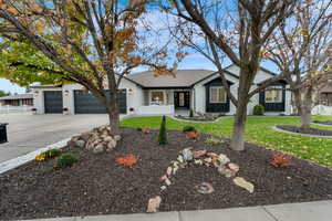 Ranch-style home featuring driveway, roof with shingles, a garage, and board and batten siding