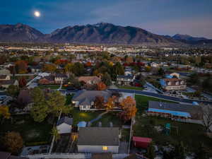 Aerial view of property's location featuring a mountain backdrop and nearby suburban area