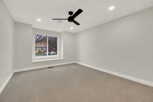 Carpeted spare room with recessed lighting and a ceiling fan