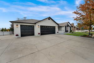 View of front of property featuring concrete driveway, an attached garage, brick siding, and roof with shingles