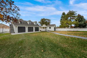 Cape cod-style house featuring a gazebo, brick siding, a garage, roof with shingles, and driveway