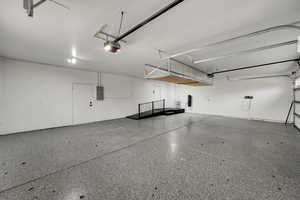 Garage with electric panel and a garage door opener