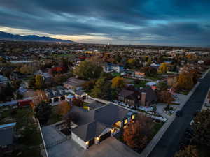 Aerial overview of property's location featuring a mountain backdrop and nearby suburban area