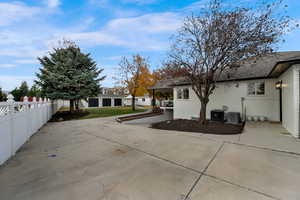 Rear view of house featuring brick siding and a patio