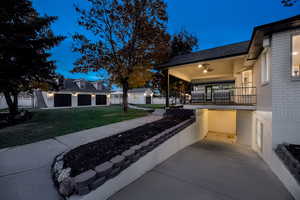 Porch featuring a lawn and a garage
