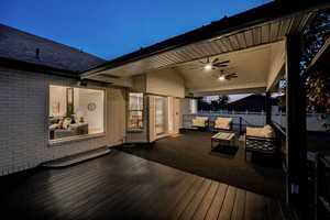 Wooden terrace with ceiling fan and outdoor lounge area