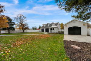 View of front facade featuring a garage and concrete driveway