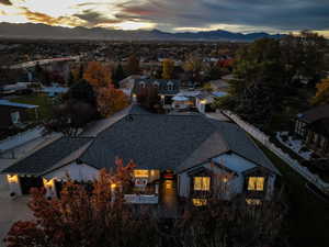 Aerial view of property and surrounding area featuring a mountain backdrop