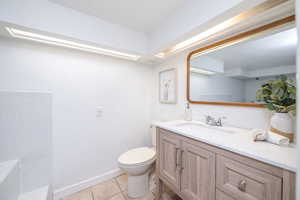 Bathroom with vanity and light tile patterned floors