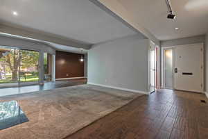 Entryway with dark wood-type flooring, rail lighting, and recessed lighting