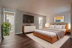 Bedroom featuring wood finished floors and baseboards