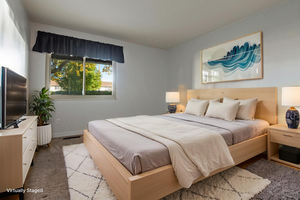 Bedroom with light carpet and baseboards