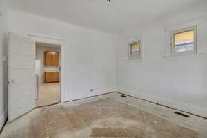 Empty room with light wood-type flooring and baseboards
