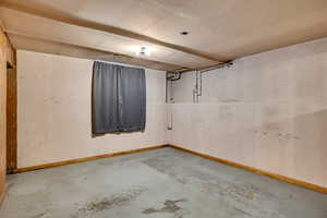 Unfinished below grade area featuring baseboards