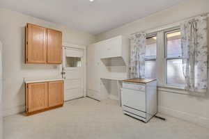 Kitchen with light flooring, healthy amount of natural light, light countertops, and white dishwasher