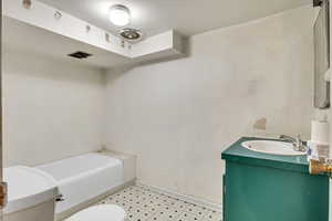 Full bath featuring vanity and a garden tub