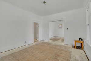 Empty room featuring crown molding and hardwood / wood-style flooring