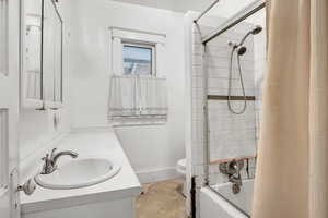 Bathroom featuring shower / bath combo and vanity