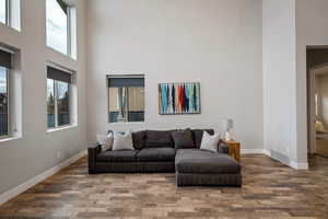 Living room with a high ceiling and wood finished floors