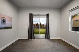 Spare room with dark carpet and healthy amount of natural light