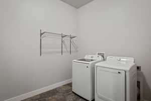 Washroom with baseboards and washer and dryer
