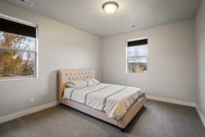 Carpeted bedroom with baseboards